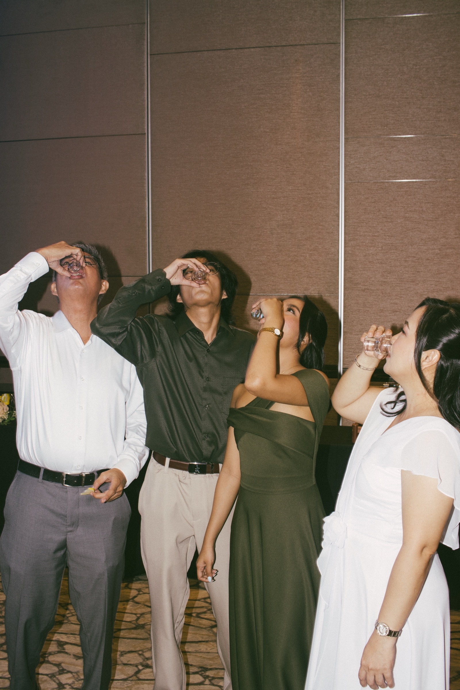 Guests tip their heads back to finish a round of shots