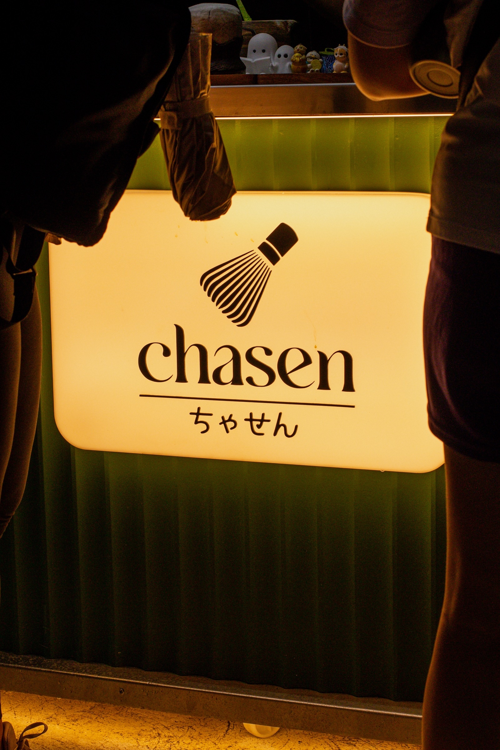 The lit sign of the Chasen matcha stall glowing in the dark